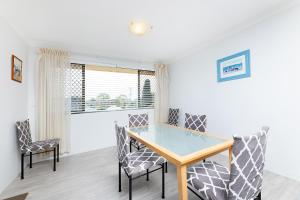 a dining room with a glass table and chairs at Braemar 6 in Forster