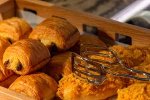 a basket of pastries with a fork in it at Sheraton Yunfu Xinxing Hotel in Yunfu