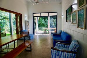 a restaurant with blue couches and a table and chairs at Gordon Town Kotch in Kingston