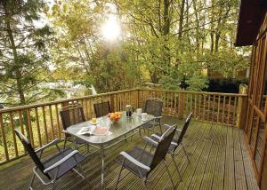 a table and chairs on a wooden deck at Jamies Cragg Holiday Park in Welburn
