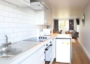 a kitchen with a sink and a counter top at North Shore Holiday Park in Winthorpe