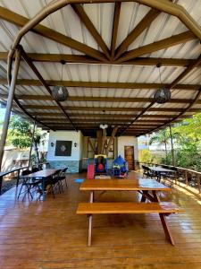a picnic table in a pavilion with tables and chairs at La Belle Staycation in Puerto Princesa City