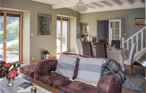 a living room with a couch and a dining room at Beautiful Home In Plouézec With Wifi in Plouézec