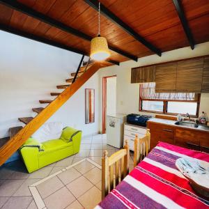 a kitchen with a table and a yellow couch in a room at Departamento independiente Amueblado Tule Oaxaca room in Santa María del Tule