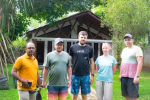 a group of people standing in front of a house at Green Cottage in Anuradhapura