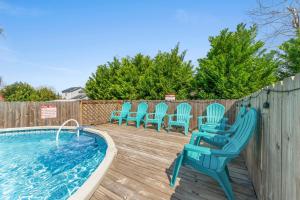 a deck with chairs and a swimming pool at Blue Oasis Beach Vacation Home with Private Pool & Hot Tub in Panama City Beach