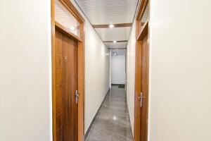 a hallway with wooden doors at FabExpress Sagar Residency in Mussoorie