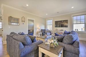 a living room with two couches and a table at Long Branch Home Less Than 1 Mi to Beach! in Long Branch