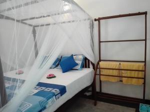 a bedroom with a bed with a canopy at Neo Grand Villa in Galle