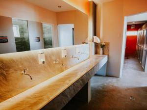 a bathroom with a long counter with sinks and mirrors at Viajeros Hostel Boracay in Boracay