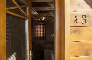 a door with a number on it next to a house at Žabljak City Center Apartments in Žabljak +78 photos