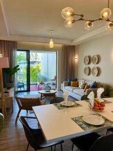 a living room with a couch and a table at Tropical beachfront apartment in Belle Mare