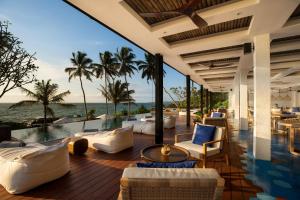 an outdoor patio with a view of the ocean at Ahu Bay in Ahungalla