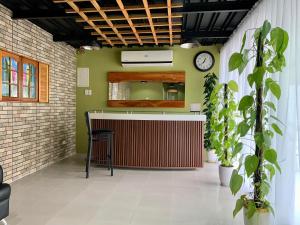 a bar in a room with a clock on the wall at Sunshine Stay Panglao in Panglao Island