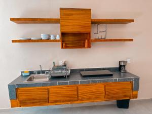 a kitchen with wooden cabinets and a sink at Kavalá in San Blas