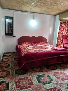 a bedroom with a bed in a room with a rug at Grand Heritage Resort in Pahalgām