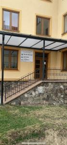 a building with a sign on the side of it at Hostel SOS Moldava in Moldava nad Bodvou