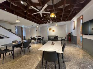 a dining room with tables and chairs and a ceiling at 九屏文旅 JP guesthouse in Xiyu