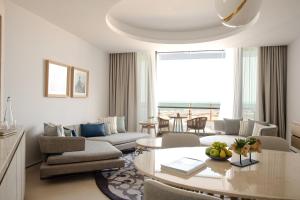 a living room with a couch and a table at Jumeirah Saadiyat Island Abu Dhabi in Abu Dhabi