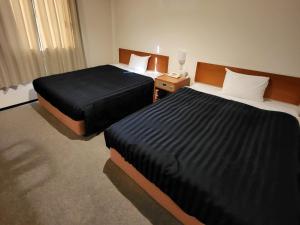 Postel nebo postele na pokoji v ubytování Hotel First Stay Amagasaki