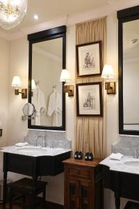 a bathroom with two sinks and a large mirror at Sela Chiangmai in Chiang Mai