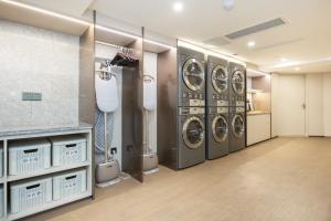 a laundry room with four washing machines in it at JI Hotel Shanghai Yan An Road Branch in Shanghai