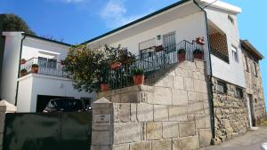 a building with potted plants on the side of it at Casa Quinta da Adega do Chão - Vale do Douro in Lamego