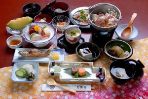 a table with many dishes of food on it at Gensenkan in Nasushiobara