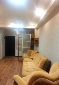 sala de estar con sofás en una habitación con suelo de madera en Срочно Сдаётся!!!, en Tiflis