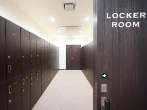 a locker room with lockers and a door at WELLCABIN TENJIN - Male Only in Fukuoka
