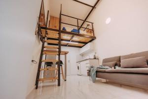 a living room with a loft bed and a couch at In the Middle of everything in Haifa