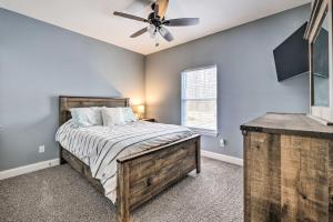 a bedroom with a bed and a ceiling fan at Waterfront Home on Lake Milton Dock, Hot Tub in Lake Milton