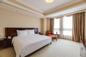 Säng eller sängar i ett rum på S&N Hotel Jiujiang