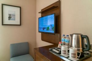 a hotel room with a desk with a computer and a tv at Midtown Hotel in Istanbul