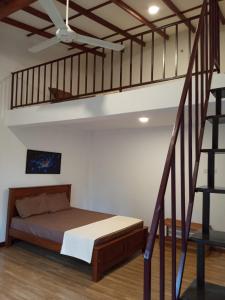 a bedroom with a bed and a staircase at Villa 95 Rangala in Kandy