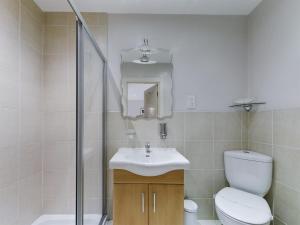 a bathroom with a toilet and a sink and a shower at Pearl Suite in Blackpool