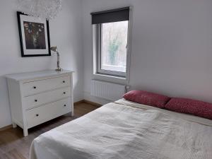 a bedroom with a bed and a dresser and a window at Schwalbennest in Bad Harzburg +16 photos