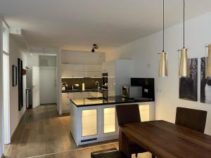 a kitchen with a table and a dining room at Schwalbennest in Bad Harzburg
