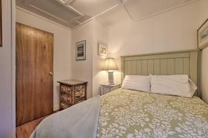 una camera da letto con un letto e una porta di legno di Waterfront Suttons Bay Cottage with Fire Pit! a Suttons Bay