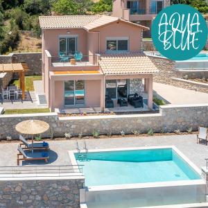 a villa with a swimming pool in front of a house at 31 Blue Ionian Villas in Apolpaina