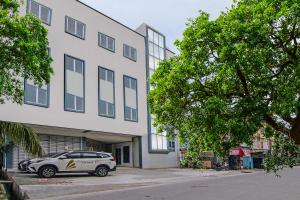 a police car parked in front of a building at SUPER OYO 92300 Koala House in Pekanbaru