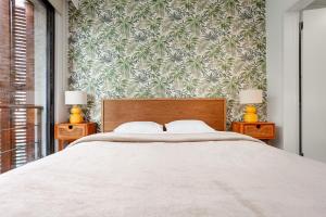 a bedroom with a large bed with a floral wallpaper at NOA - Ali Hoca 6 in Istanbul