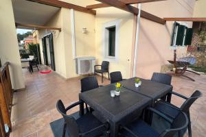 a patio with a black table and chairs at Detached house with pool nearby Girona in Sant Julià De Ramis