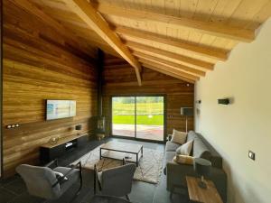 a living room with a couch and a table at Unique ! Chalet Grand Standing, la Nature pour vis à vis in Les Rousses