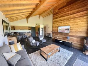 ein Wohnzimmer mit einem Sofa und einem Tisch in der Unterkunft Unique ! Chalet Grand Standing, la Nature pour vis à vis in Les Rousses