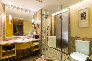 a bathroom with a shower and a sink and a toilet at S&N Hotel Jiujiang in Jiujiang