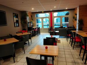 a restaurant with tables and chairs and a cafeteria at Cafe de france Eauze in Eauze
