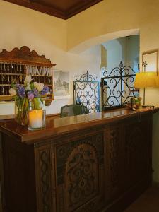 a large wooden counter with a vase of flowers on it at Hotel Zur Post in Alpbach