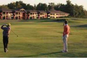 two people playing golf on a golf course at Studio avec Piscine in Saint-Médard-en-Jalles