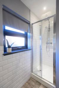 a bathroom with a shower and a glass shower door at The Imp’s Pad - Off Steep Hill - Private Parking in Lincolnshire